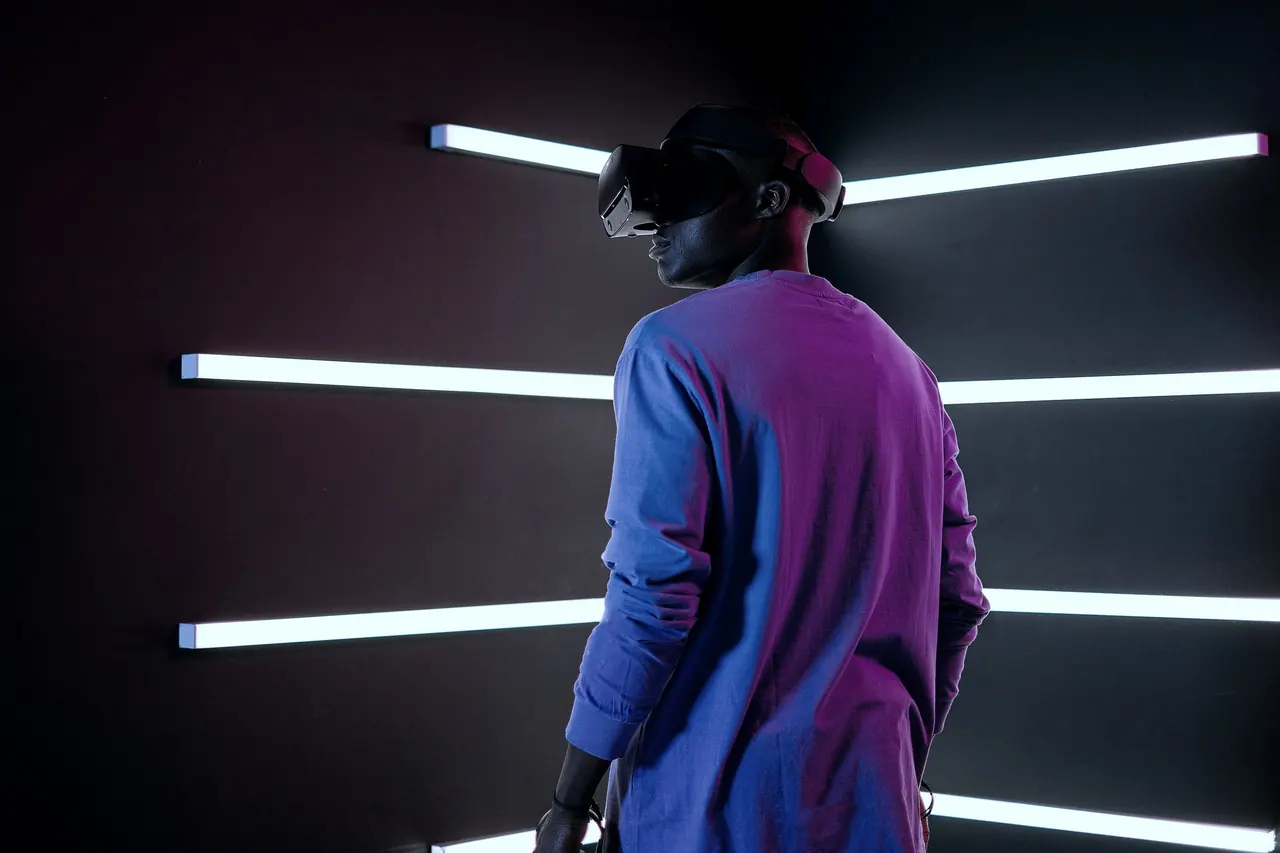 A person standing in a room lit by lines of light