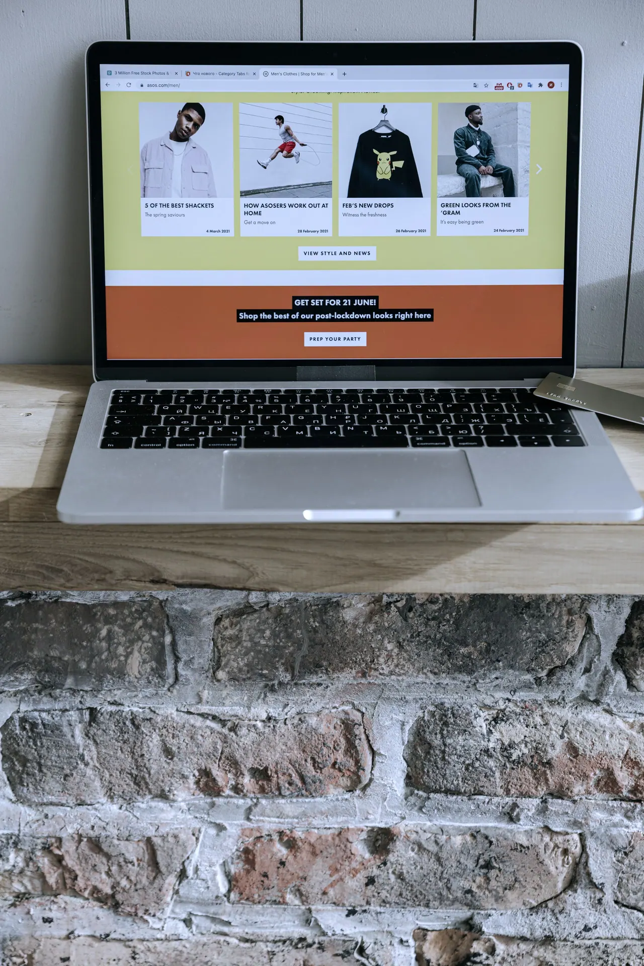 A laptop showing an online shop on a wooden desk
